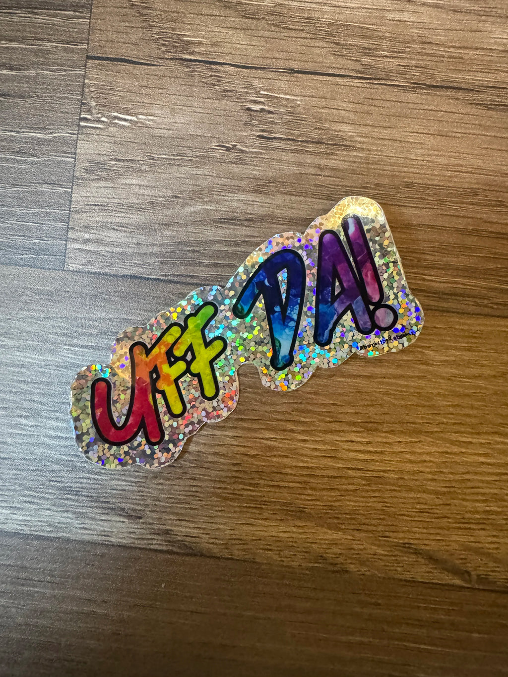 B-Grade Rainbow Glittery Uff Da Glossy Sticker